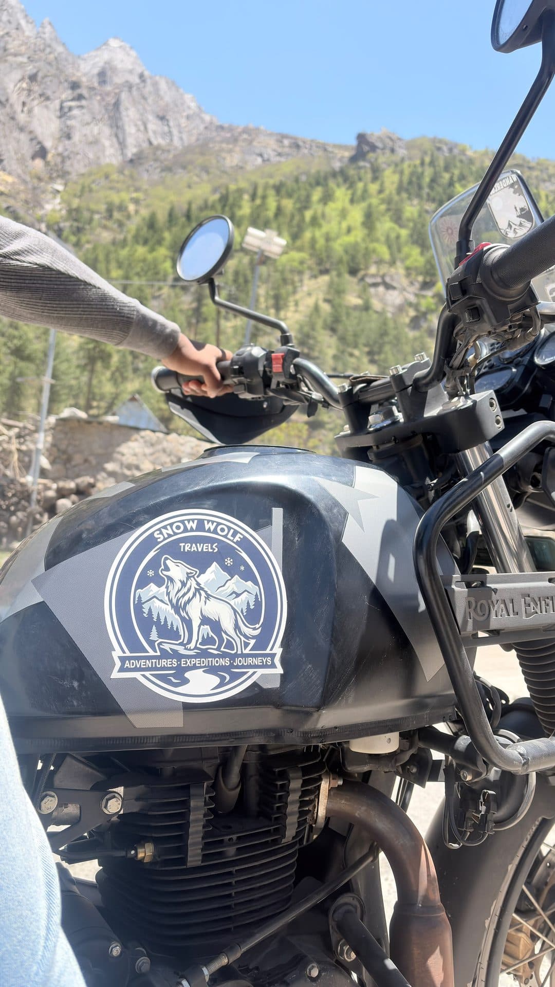 Close-up of the Snow Wolf Travels badge on a motorcycle tank